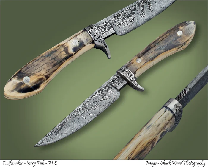 Two Damascus knives with stag handles and engraved bolsters on a green ground.