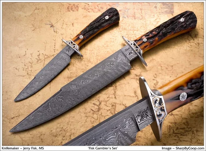 A set of small matching knives arranged in a fan around an engraved medallion, on a red ground.