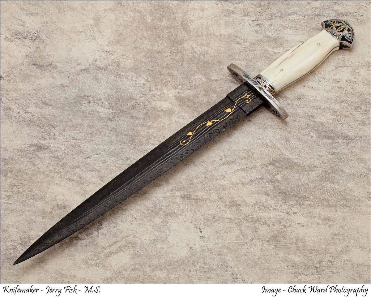 A Jerry Fisk dagger: a Damascus blade with a fluted ivory handle and an engraved guard.